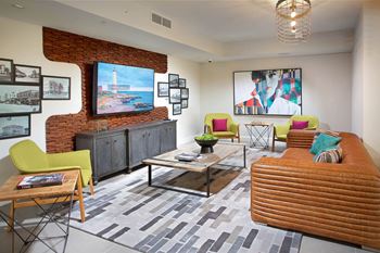 Resident lounge with billiards table, shuffleboard, card room, demonstration kitchen, and more
